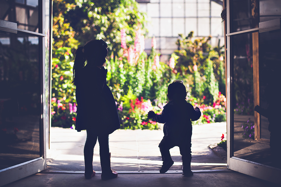 Sibling silhouette greenhouse flowers | Tonya Teran Photography, Potomac, MD newborn, baby and family photographer